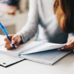 woman writing using pen